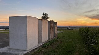 Vier Quadersteine der Zeitpyramide mit Blick auf einen Sonnenuntergang.