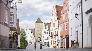 Zwei Radfahrer fahren zusammen in der historischen Altstadt in der Wallfahrtstraße.